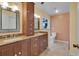 Bathroom with double vanity, wooden cabinets, and tiled floor at 105 Valley Ct, Longwood, FL 32779