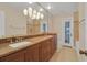 Bathroom featuring double vanity, granite countertop, custom lighting and tile shower at 105 Valley Ct, Longwood, FL 32779