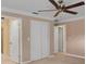 Bright bedroom with a ceiling fan and double-door closet at 105 Valley Ct, Longwood, FL 32779