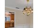 Dining room with a decorative light fixture with an archway leading to the kitchen at 105 Valley Ct, Longwood, FL 32779
