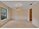 Bright dining room with carpet flooring, paneled walls, and a decorative chandelier creates a welcoming space at 105 Valley Ct, Longwood, FL 32779