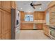 Well-lit kitchen featuring wood cabinets, granite countertops, and stainless steel appliances including refrigerator and dishwasher at 105 Valley Ct, Longwood, FL 32779