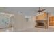 The living room features a brick fireplace, tile flooring and ample natural light at 105 Valley Ct, Longwood, FL 32779