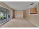 Light-filled living room with large window, neutral carpet and paneled walls at 105 Valley Ct, Longwood, FL 32779