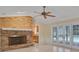 The living room features a brick fireplace, tiled floor, and access to the pool at 105 Valley Ct, Longwood, FL 32779