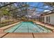 Beautiful pool surrounded by a screened enclosure and lush landscaping at 105 Valley Ct, Longwood, FL 32779