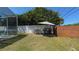 Expansive backyard with pool, grill, and white fence, perfect for outdoor gatherings and recreation at 10879 Norcross Cir, Orlando, FL 32825