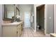 Beautiful bathroom features double vanity, a white door to outside, and a commode at 10879 Norcross Cir, Orlando, FL 32825