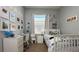 Well-lit bedroom with a bed, desk, and shelving for decor at 10879 Norcross Cir, Orlando, FL 32825