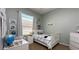Bright bedroom with a bed, desk, and shelving for books or trophies at 10879 Norcross Cir, Orlando, FL 32825