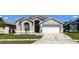 Charming single-Gathering home featuring a well-manicured lawn and a two-car garage at 10879 Norcross Cir, Orlando, FL 32825