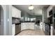 Open-concept kitchen with stainless steel appliances and a tile backsplash at 10879 Norcross Cir, Orlando, FL 32825