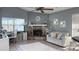 Cozy living room featuring a stone fireplace, lots of light and modern décor at 10879 Norcross Cir, Orlando, FL 32825