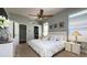 Comfortable main bedroom with ceiling fan, walk-in closet, and bright natural lighting at 10879 Norcross Cir, Orlando, FL 32825