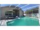 Relaxing screened-in pool with an umbrella and plenty of space for seating at 10879 Norcross Cir, Orlando, FL 32825