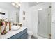 Elegant bathroom featuring a modern vanity, white vessel sink, and a glass-enclosed shower at 11718 Fitzgerald Butler Rd, Orlando, FL 32836