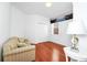 Simple bedroom featuring hardwood floors, a striped couch, and natural light at 11718 Fitzgerald Butler Rd, Orlando, FL 32836