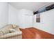 Minimal bedroom with hardwood floors, a couch, and a window with plantation shutters at 11718 Fitzgerald Butler Rd, Orlando, FL 32836