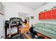 Exercise area with various machines, hardwood floors, and an open view to the living space at 11718 Fitzgerald Butler Rd, Orlando, FL 32836