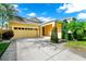 Inviting one-story home with a covered front entry, two-car garage, lush lawn and mature landscaping at 11718 Fitzgerald Butler Rd, Orlando, FL 32836