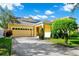 Charming single-Gathering home featuring a two-car garage, well-maintained lawn, and mature landscaping at 11718 Fitzgerald Butler Rd, Orlando, FL 32836