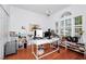 Bright home office with a decorative window, a large white desk, and hardwood floors at 11718 Fitzgerald Butler Rd, Orlando, FL 32836