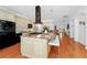 Well-appointed kitchen island with a cooktop and bar seating with open view of the living spaces at 11718 Fitzgerald Butler Rd, Orlando, FL 32836