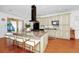 Gourmet kitchen featuring a large center island with seating and a modern vent hood at 11718 Fitzgerald Butler Rd, Orlando, FL 32836