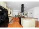 Gourmet kitchen with a central island featuring bar seating and views of the dining area and TV at 11718 Fitzgerald Butler Rd, Orlando, FL 32836