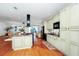 Spacious kitchen with wood flooring, a central island with bar seating, and sleek black appliances at 11718 Fitzgerald Butler Rd, Orlando, FL 32836
