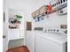 Functional laundry room with washer, dryer, storage shelves, and ironing board for added convenience at 11718 Fitzgerald Butler Rd, Orlando, FL 32836