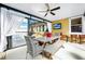 Covered patio featuring a dining area, a television, and bright natural light at 11718 Fitzgerald Butler Rd, Orlando, FL 32836