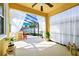 Cozy screened patio with a bar area, decorative curtains, and a seating space at 11718 Fitzgerald Butler Rd, Orlando, FL 32836