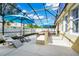 Screened in patio with a built in outdoor kitchen, and chaise lounge seating at 11718 Fitzgerald Butler Rd, Orlando, FL 32836