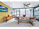 Enclosed patio featuring a ceiling fan, a television, and wooden dining furniture at 11718 Fitzgerald Butler Rd, Orlando, FL 32836
