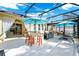 Large screened patio with outdoor kitchen, dining area, and chaise lounge seating at 11718 Fitzgerald Butler Rd, Orlando, FL 32836