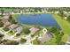 Aerial shot of a home in a cul-de-sac near a pond, highlighting its screened pool and landscaping at 128 Hallstrom Ct, Debary, FL 32713