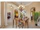 Elegant dining room with open view to office and living area, accentuated by pillars and natural light at 128 Hallstrom Ct, Debary, FL 32713