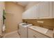 Well-equipped laundry room with modern appliances, ample storage, and a functional sink area for added convenience at 128 Hallstrom Ct, Debary, FL 32713