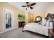 Spacious main bedroom with plush carpet, TV, and a private exterior door at 128 Hallstrom Ct, Debary, FL 32713