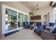 Outdoor patio with comfortable seating, a TV, bar and views through a screen of the pool at 128 Hallstrom Ct, Debary, FL 32713