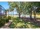 Backyard view showcasing a serene pond and verdant landscaping, creating a peaceful setting at 128 Hallstrom Ct, Debary, FL 32713