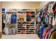 Large walk-in closet with well-organized shelves and hanging rods, providing ample storage and easy access to clothing at 128 Hallstrom Ct, Debary, FL 32713
