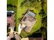 Aerial shot of home with a pool, screened in lanai, solar panels and circular driveway at 128 Hallstrom Ct, Debary, FL 32713