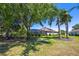 Beautiful backyard featuring a screened-in lanai, lush landscaping, and mature trees at 128 Hallstrom Ct, Debary, FL 32713