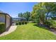 Large, well-maintained backyard with a screened-in lanai and lush landscaping with view of lake at 128 Hallstrom Ct, Debary, FL 32713