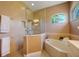 This elegant bathroom features a separate tub, a shower stall, and neutral walls at 128 Hallstrom Ct, Debary, FL 32713