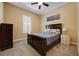 This bedroom has a ceiling fan, dresser, side table with lamp, and a window with shutters at 128 Hallstrom Ct, Debary, FL 32713