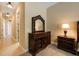 Bedroom showing dresser with mirror, side table with lamp, and hallway entry at 128 Hallstrom Ct, Debary, FL 32713