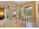 Bright dining area with modern chandelier and views of the pool and outdoor space through arched windows at 128 Hallstrom Ct, Debary, FL 32713
